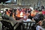 attendees relax around a cozy fire (Copy)